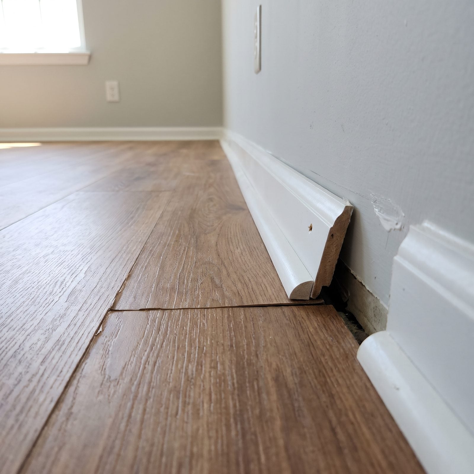 Quarter-Round Trim Hiding the Flooring Gaps