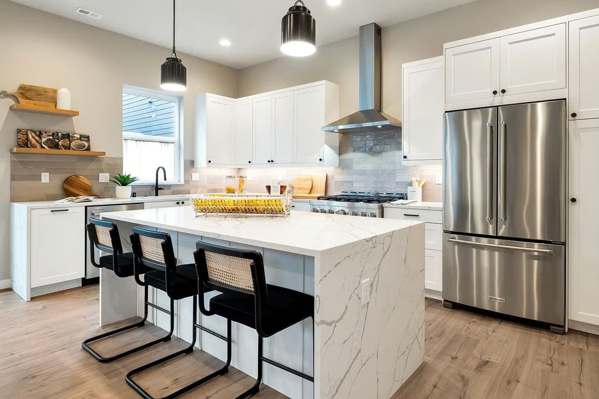 Marble Waterfall Island Takes Center Stage in a Kitchen That Means Business