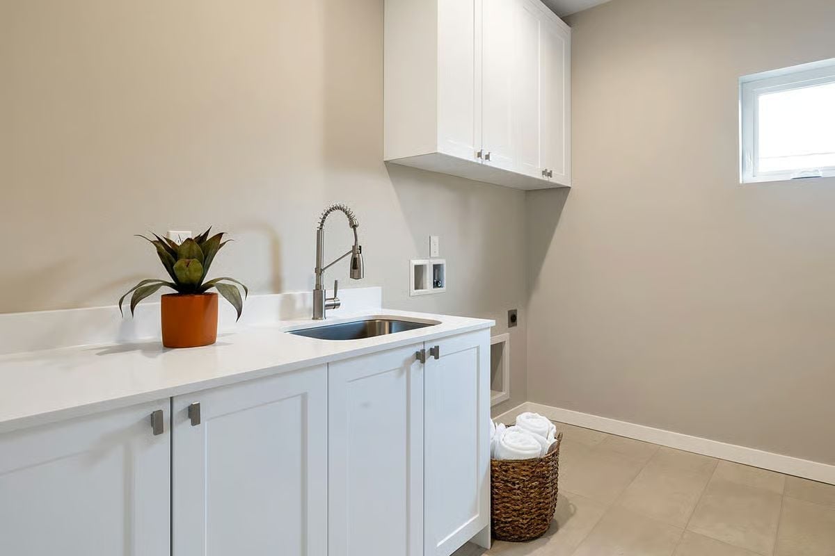Stainless Sink and a Pull-Down Faucet Keep This Laundry Room Strictly Functional
