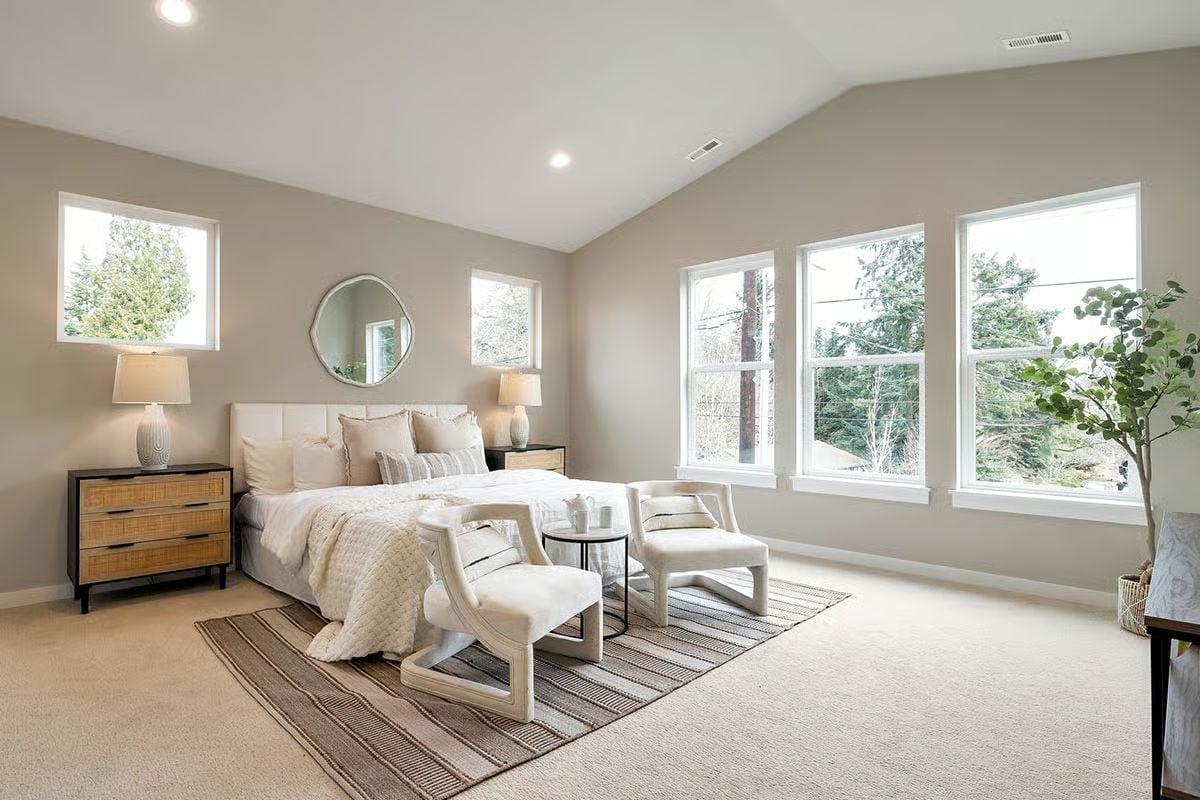 Vaulted Ceiling and Triple Windows Make This Primary Bedroom Feel Twice Its Size
