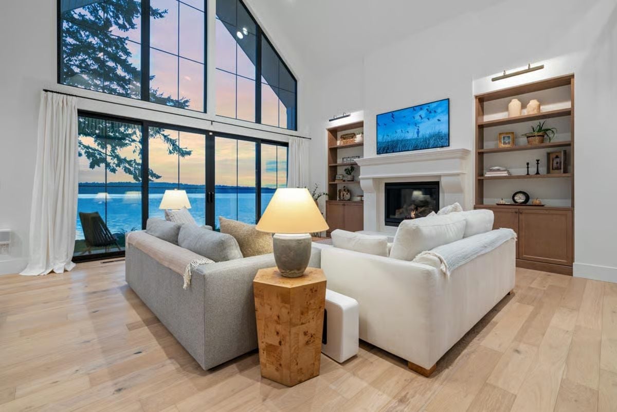 Floor-to-Ceiling Lake Views Anchored by a Fireplace Worth Gathering Around