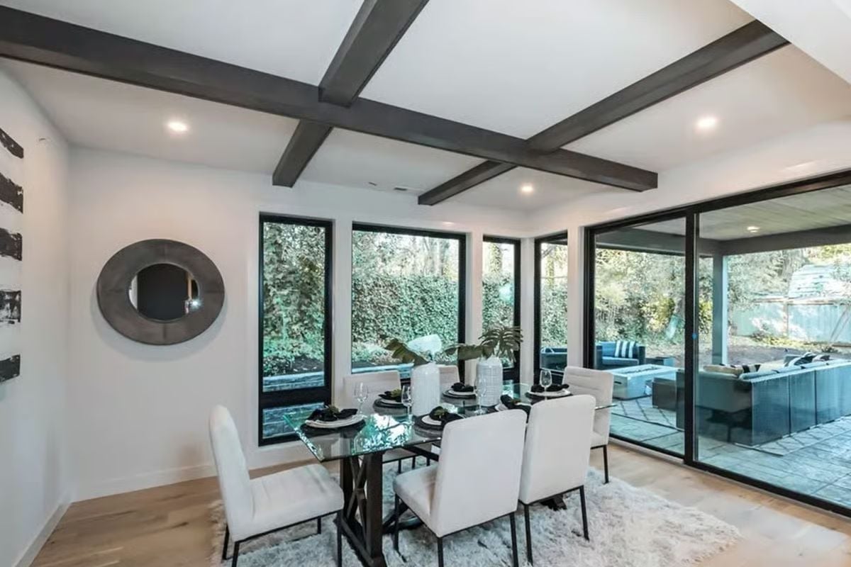 Coffered Beams and a Glass Table Give This Dining Room Two Competing Focal Points