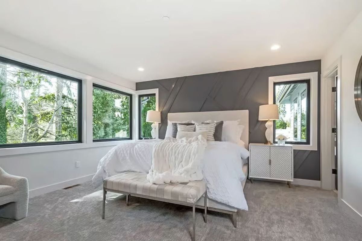 Geometric Accent Wall and Corner Windows Keep This Primary Bedroom from Playing It Safe