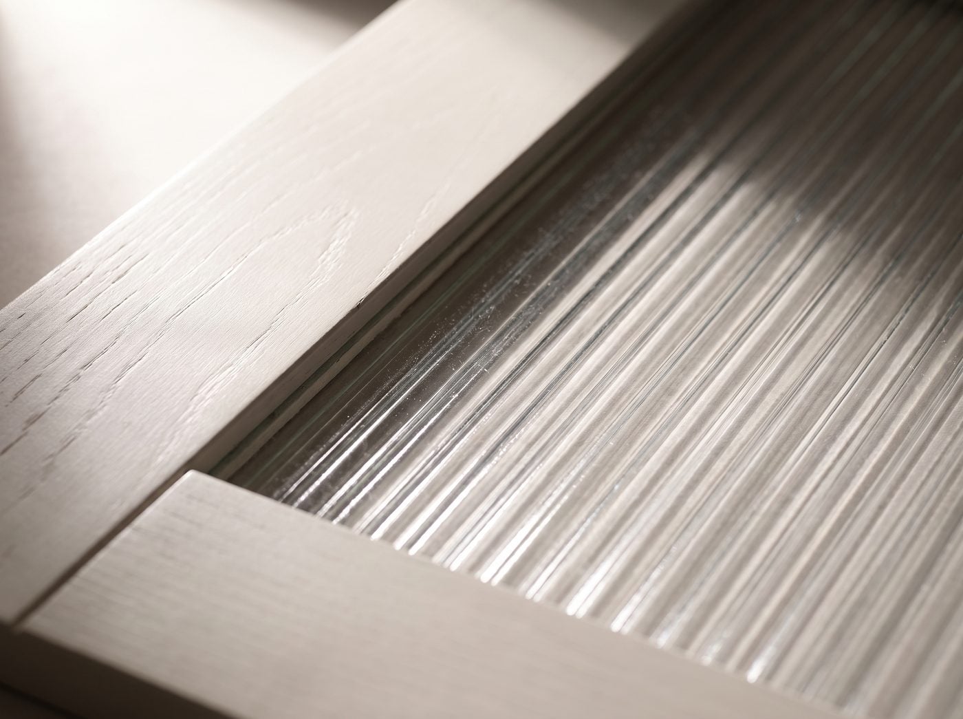 Reeded Glass-Front detail: ribbed reeded glass blurring the cabinet contents.