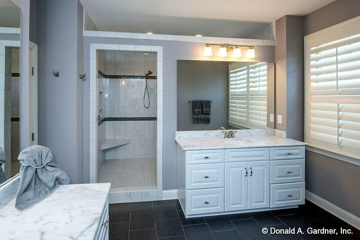 Marble Counters and Dark Tile Make This Master Bath Worth the Square Footage
