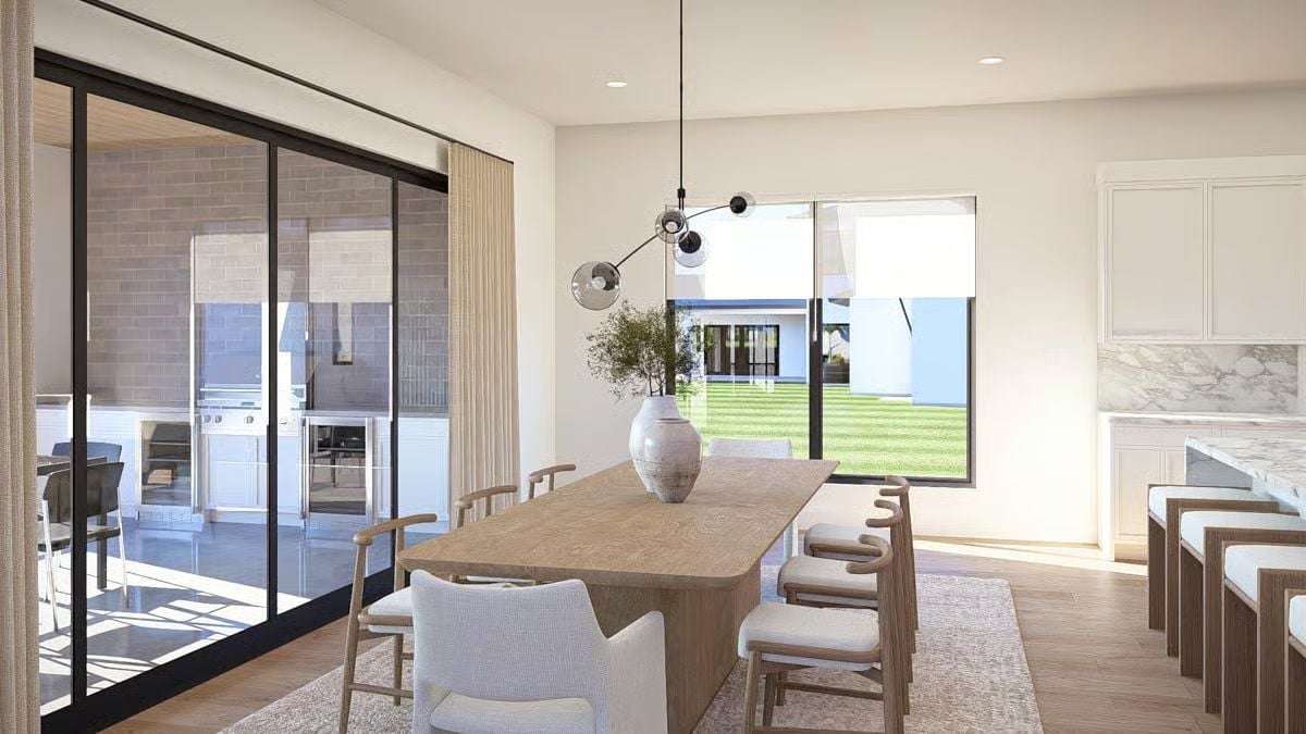 Sliding Doors, Outdoor Kitchen Views, and a Pendant That Earns the Ceiling