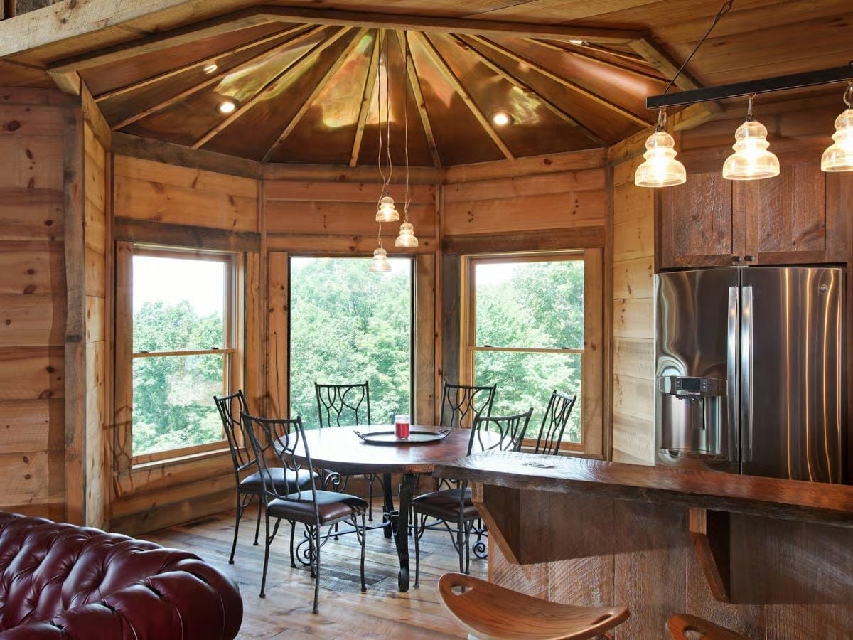 Octagonal Ceiling Framing and Telegraph Insulator Pendants Anchor This Dining Nook