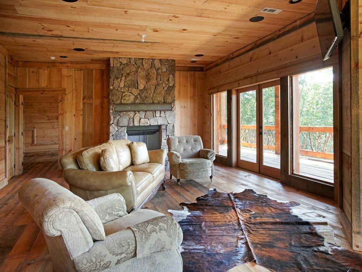 Stone Fireplace and Cowhide Rug Set the Tone Before You Sit Down