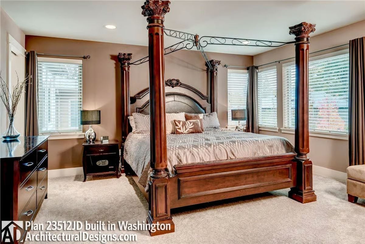 Corinthian-Capped Posts and Wrought Iron Make This Canopy Bed Its Own Architecture