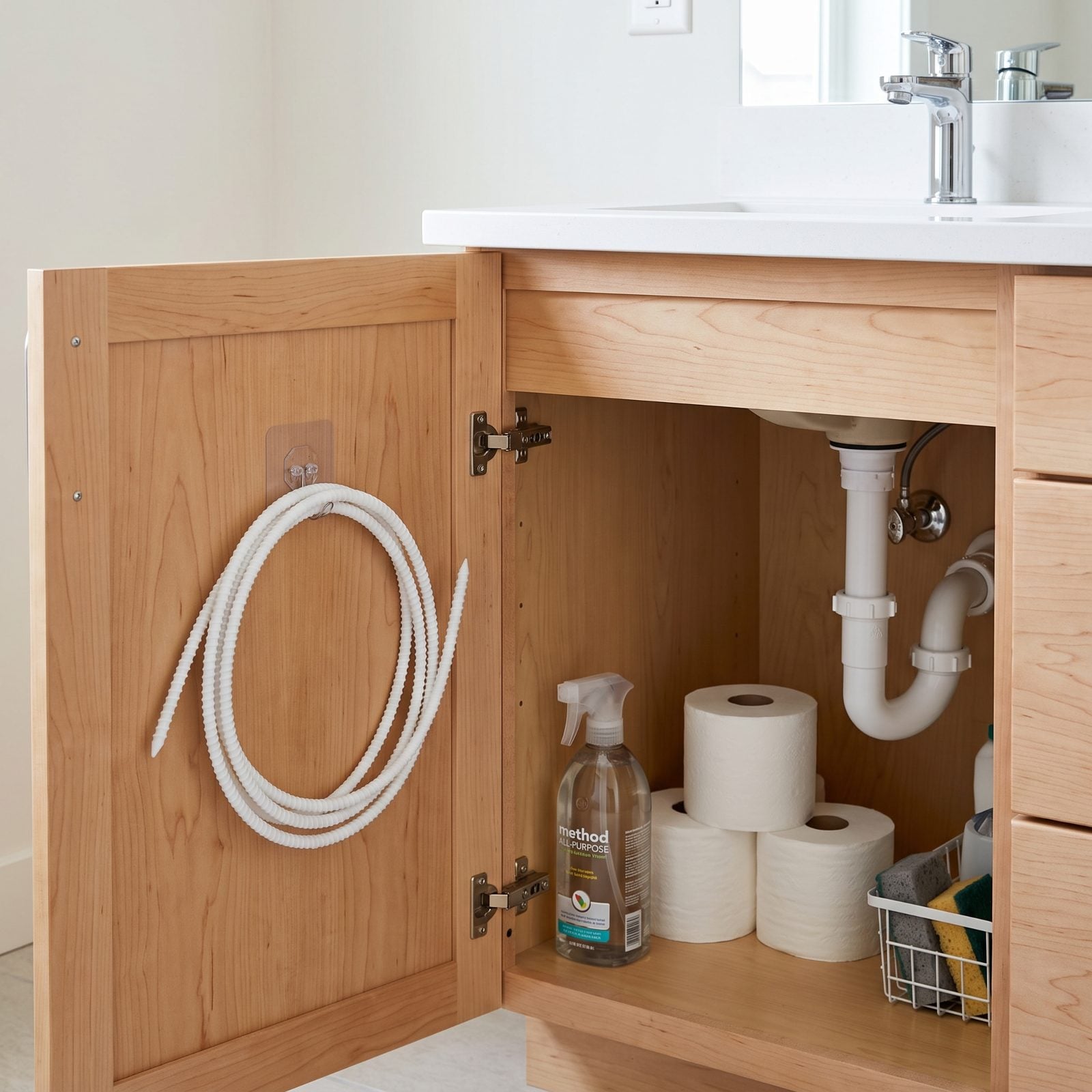 A Small Drain Snake Stored Under Each Bathroom Sink