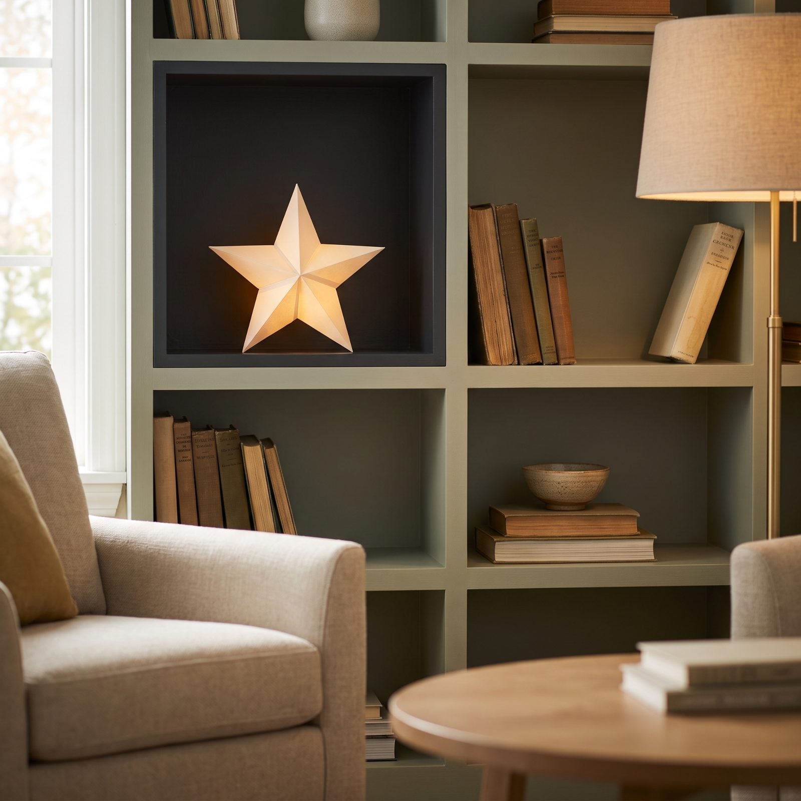 A Small Paper Star Tucked Into a Dark Shelf Cubby