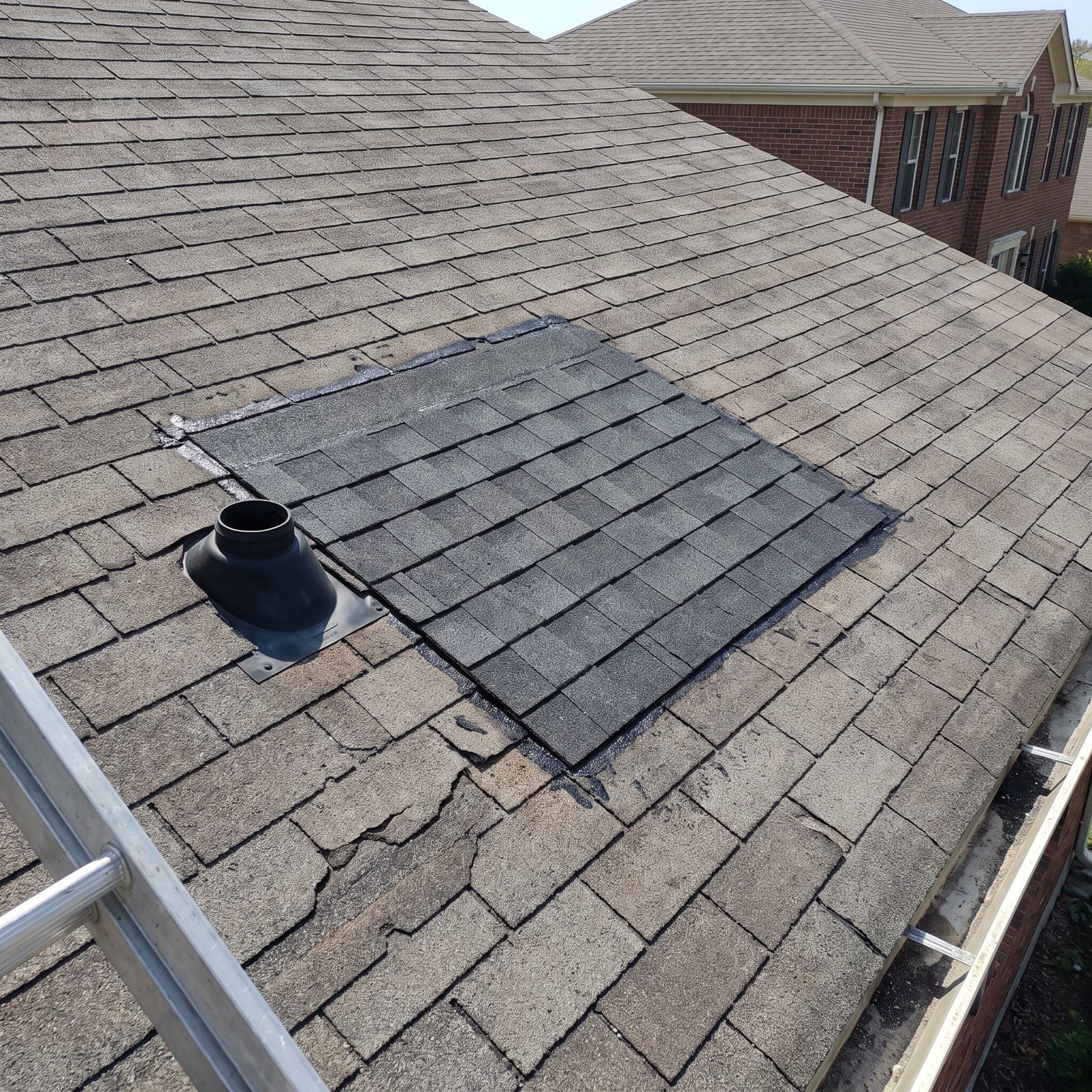 A Small Roof Section With Mismatched Shingles