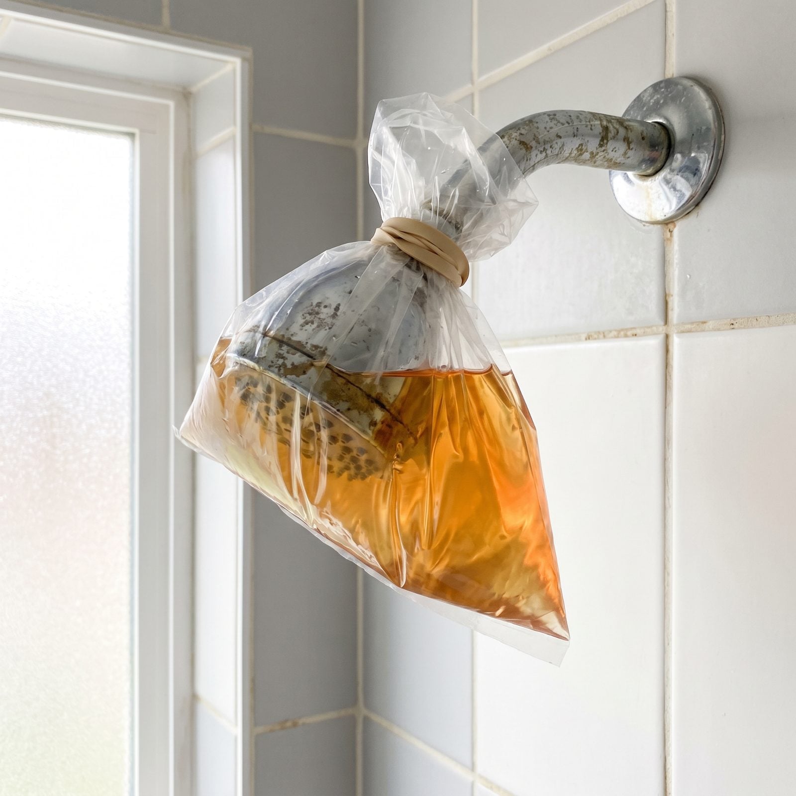 Soak a Crusted Showerhead in a Bag of Vinegar