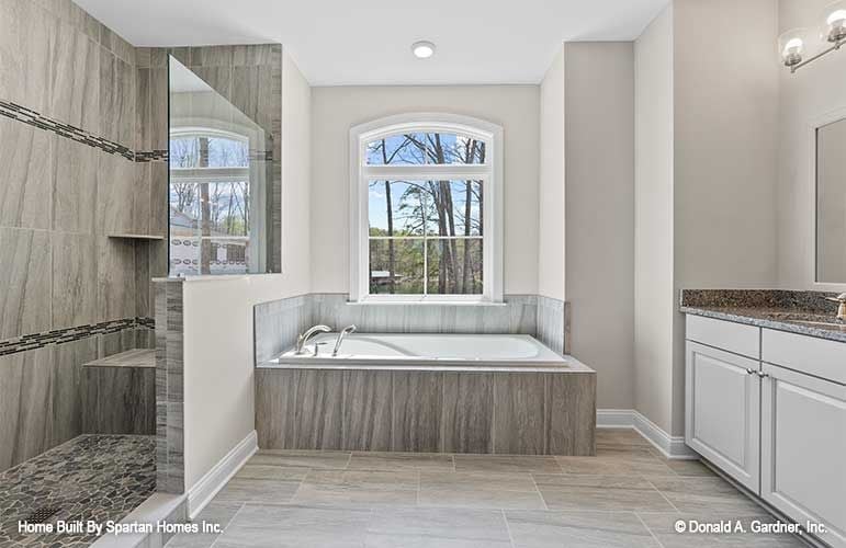 Soaking Tub Framed by an Arched Window That Actually Earns the Square Footage