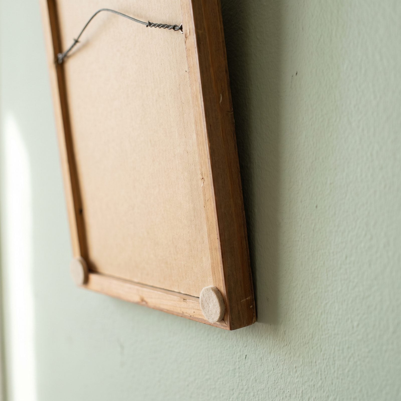 Stick Felt Pads Behind Frames to Keep Them Level