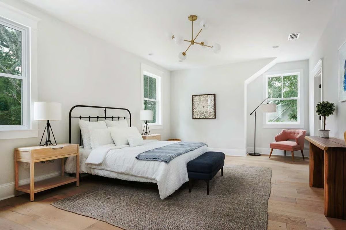 Iron Bed Frame, Gold Chandelier, Pink Chair — Three Choices That Shouldn't Work Together But Do