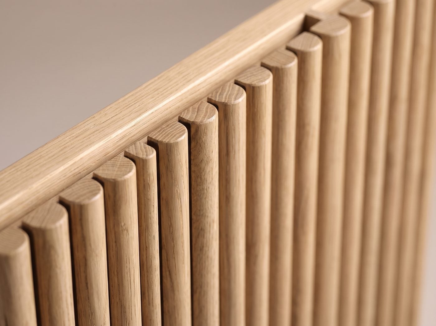 Tambour-Inspired detail: half-round oak slats with shadow gaps.