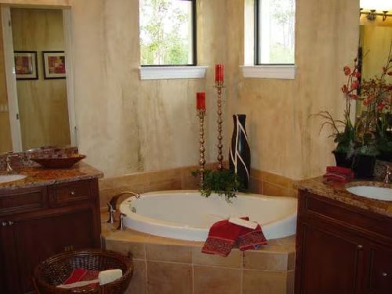 Candlelit Soaking Tub With Red Accents That Make Relaxation Feel Intentional