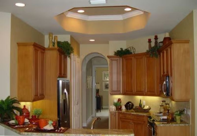 Octagonal Tray Ceiling and Warm Cabinetry Give This Kitchen Its Backbone