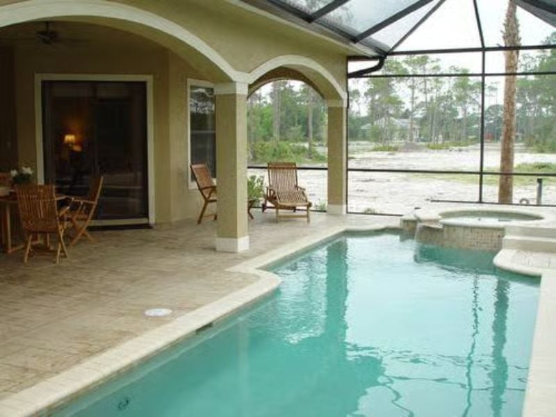 Screened Pool and Spa Under Arched Columns That Actually Earn Their Keep