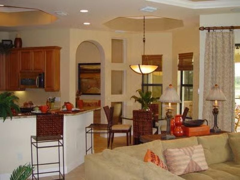 Warm Arches and Terracotta Tones Pull the Kitchen Into the Living Room