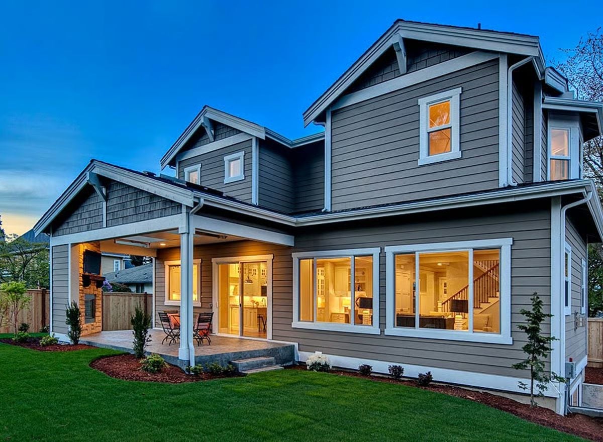 Gray Lap Siding, a Covered Patio, and Large Sliding Doors That Pull the Yard In