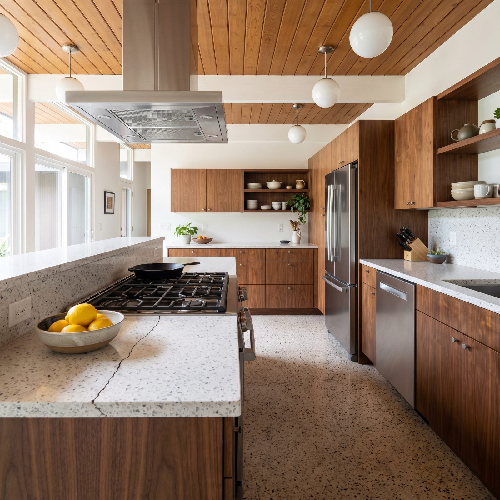 White quartz counter with a hairline crack running diagonally from the corner of a gas cooktop cutout.