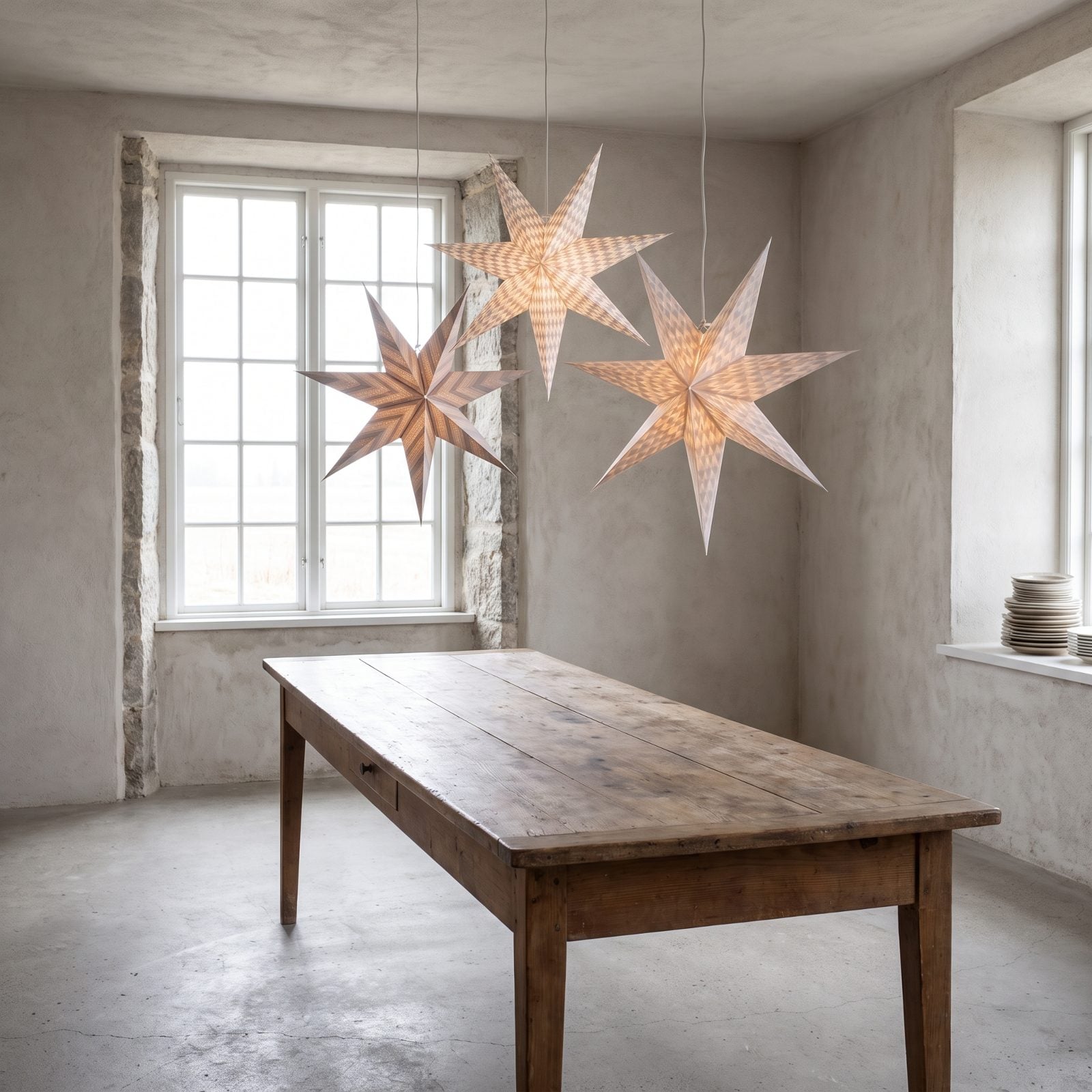 Three Oversized Paper Stars in an Otherwise Bare Dining Room