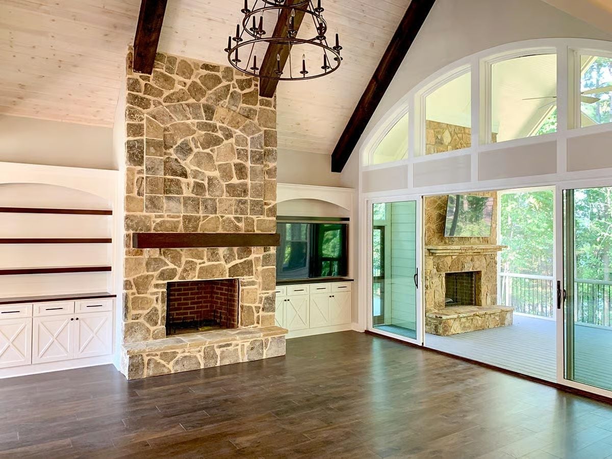 Double-Sided Stone Fireplace Built for Indoor-Outdoor Living