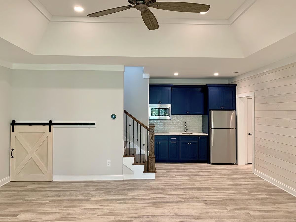 Navy Cabinets and a Barn Door Pull Basement Living Out of the Ordinary