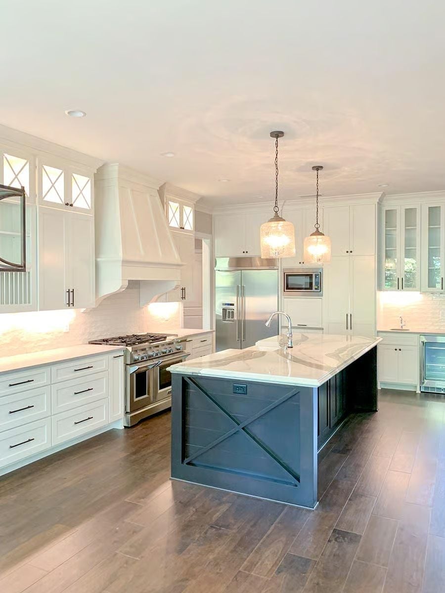 Navy Island with X-Brace Panels Anchors a Mostly White Kitchen