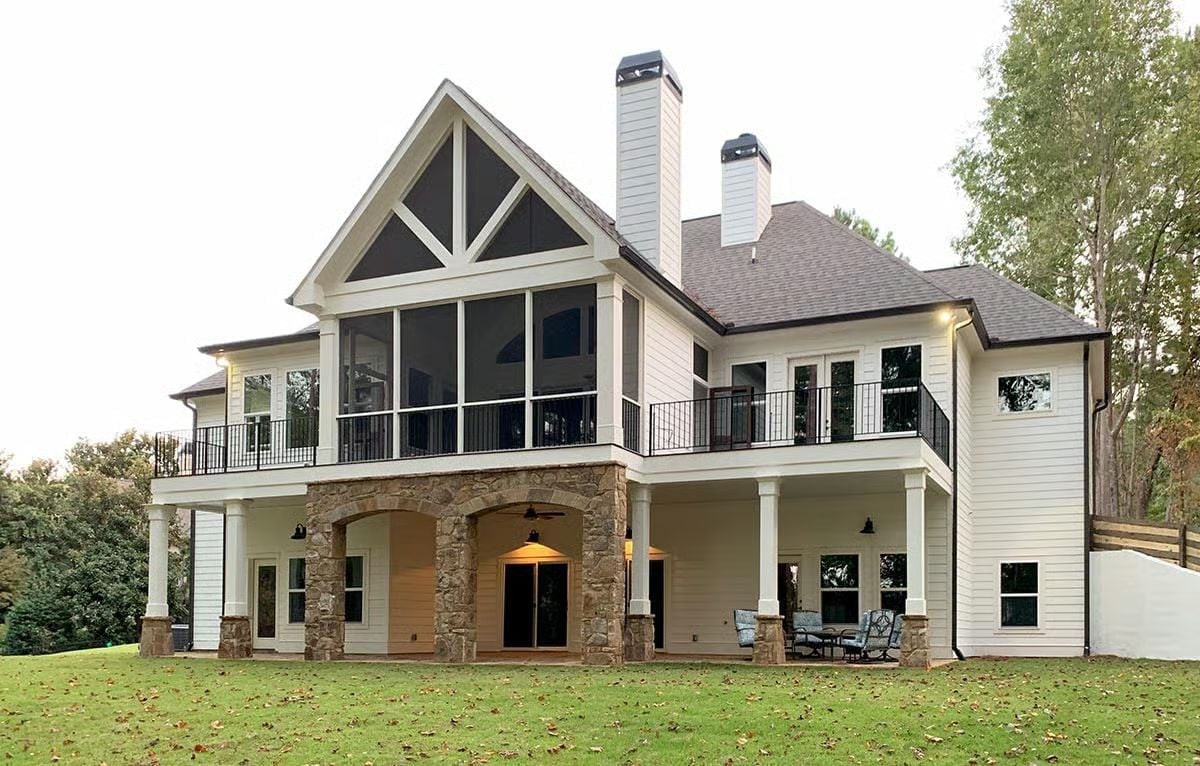 Screened Porch Perched Over Stone Arches With Two Chimneys in View
