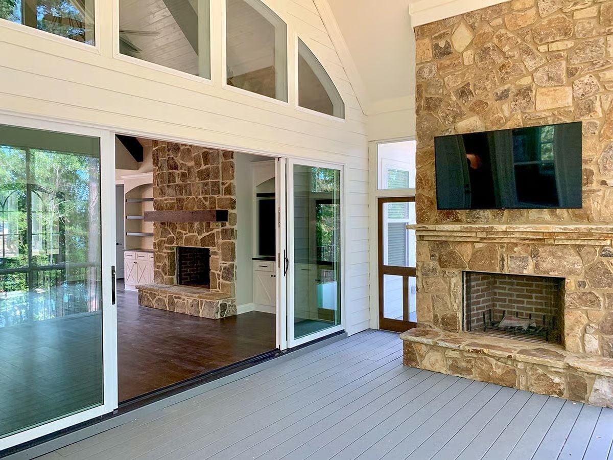 Sliding Glass Walls Let Two Fireplaces Share the Same View
