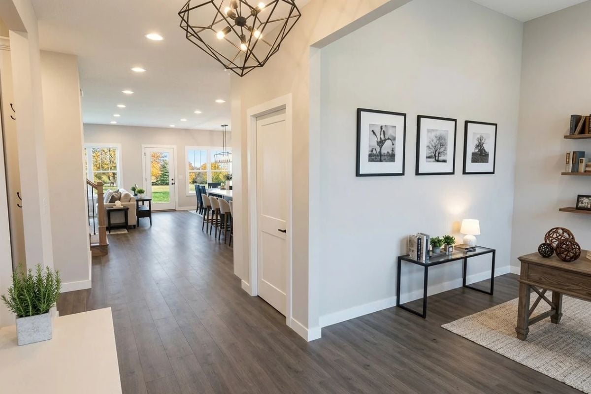 Geometric Pendant, Dark Hardwood, and Three Black-and-White Frames That Hold the Wall Together