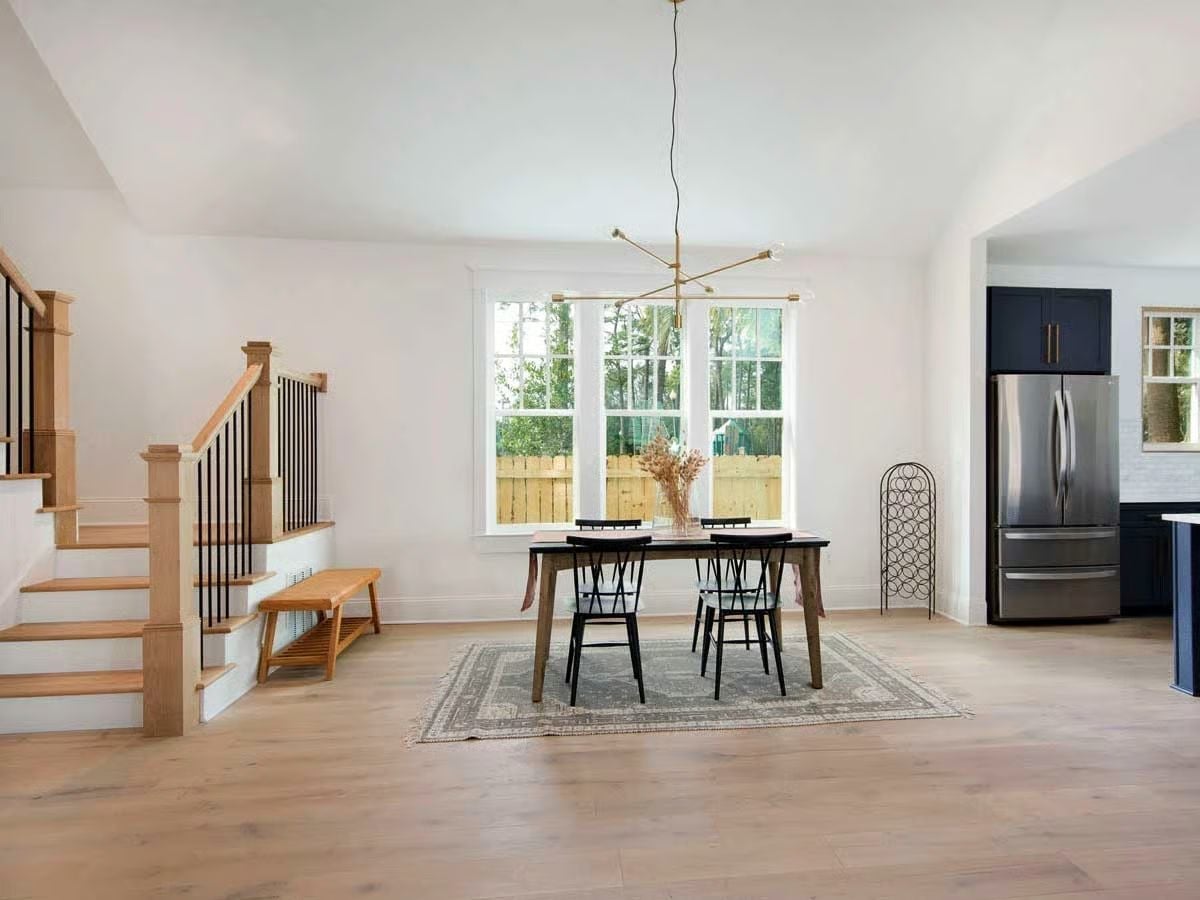 Midcentury Chandelier and Black Wishbone Chairs Give This Dining Room Its Edge