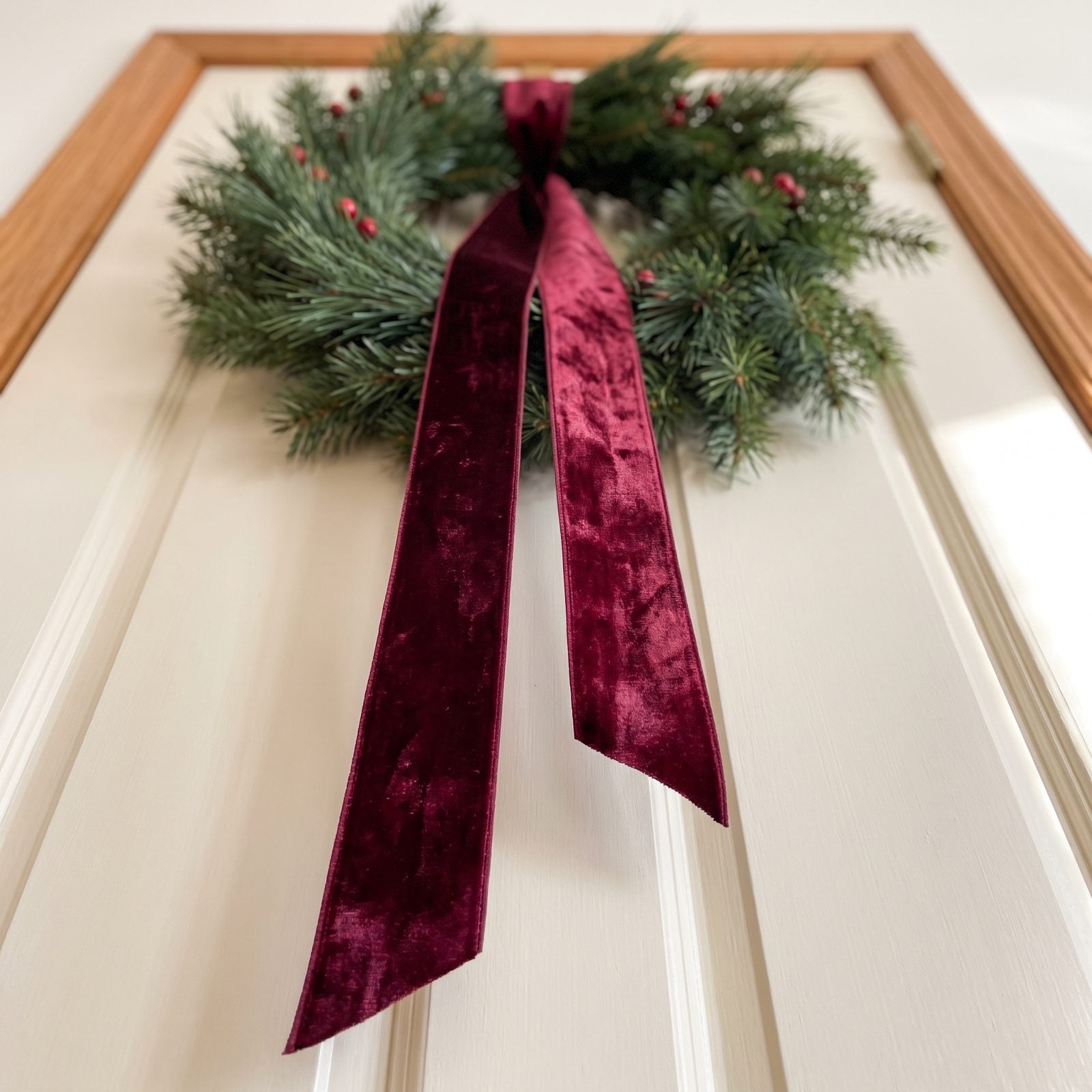 A Velvet Ribbon Tail Trailing from a Wreath