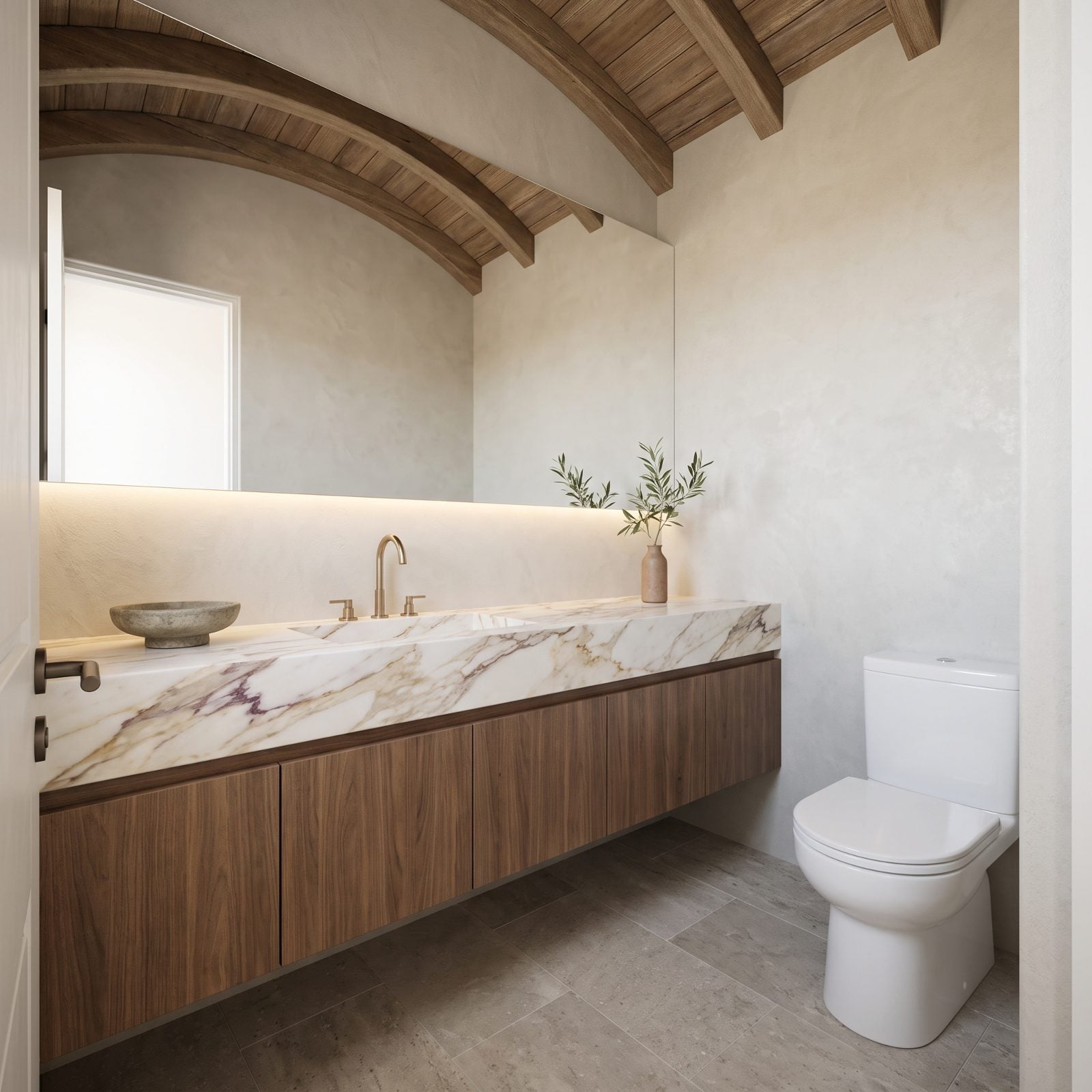 A Wall-to-Wall Marble Ledge Over Handleless Walnut Cabinets