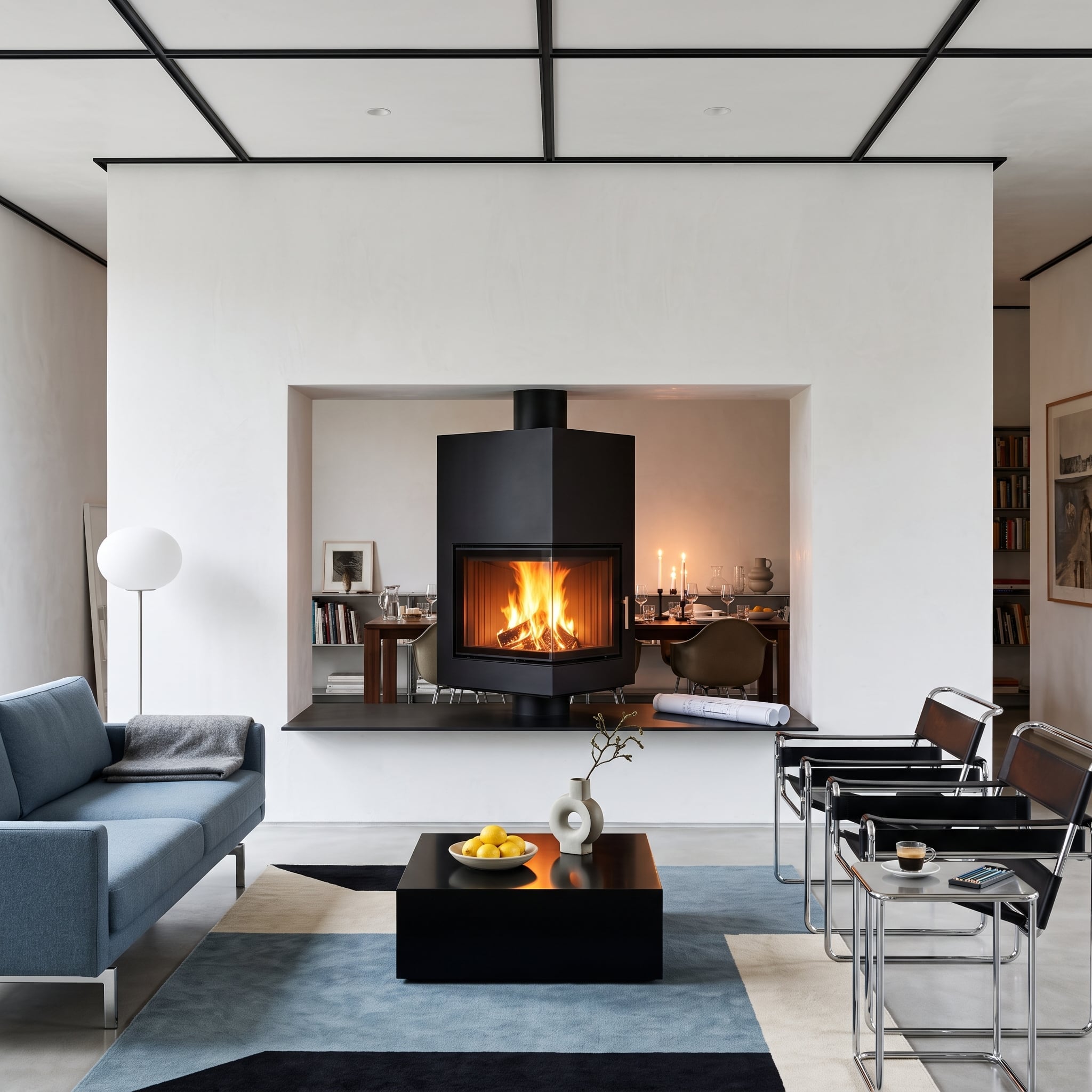 See-through fireplace centered in a white plaster partition