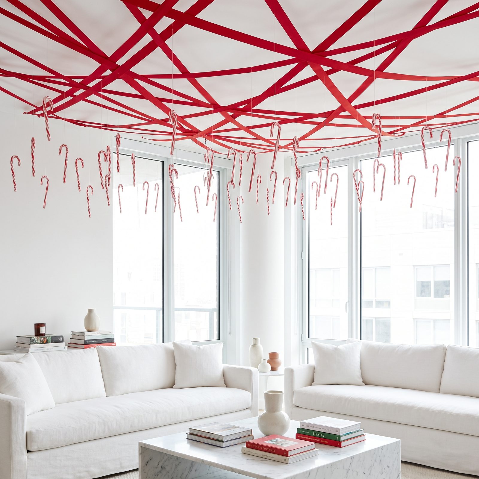A White Living Room Beneath Red Ribbons and Floating Candy Canes
