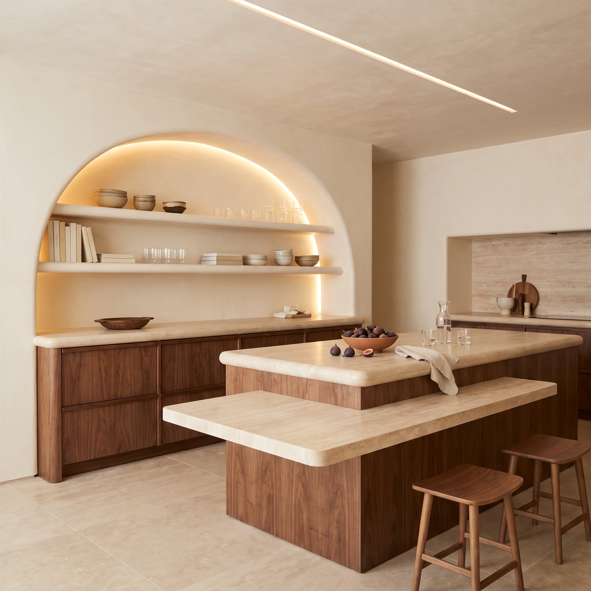 Contemporary walnut kitchen with illuminated shelves inside an arched plaster niche and two-level island