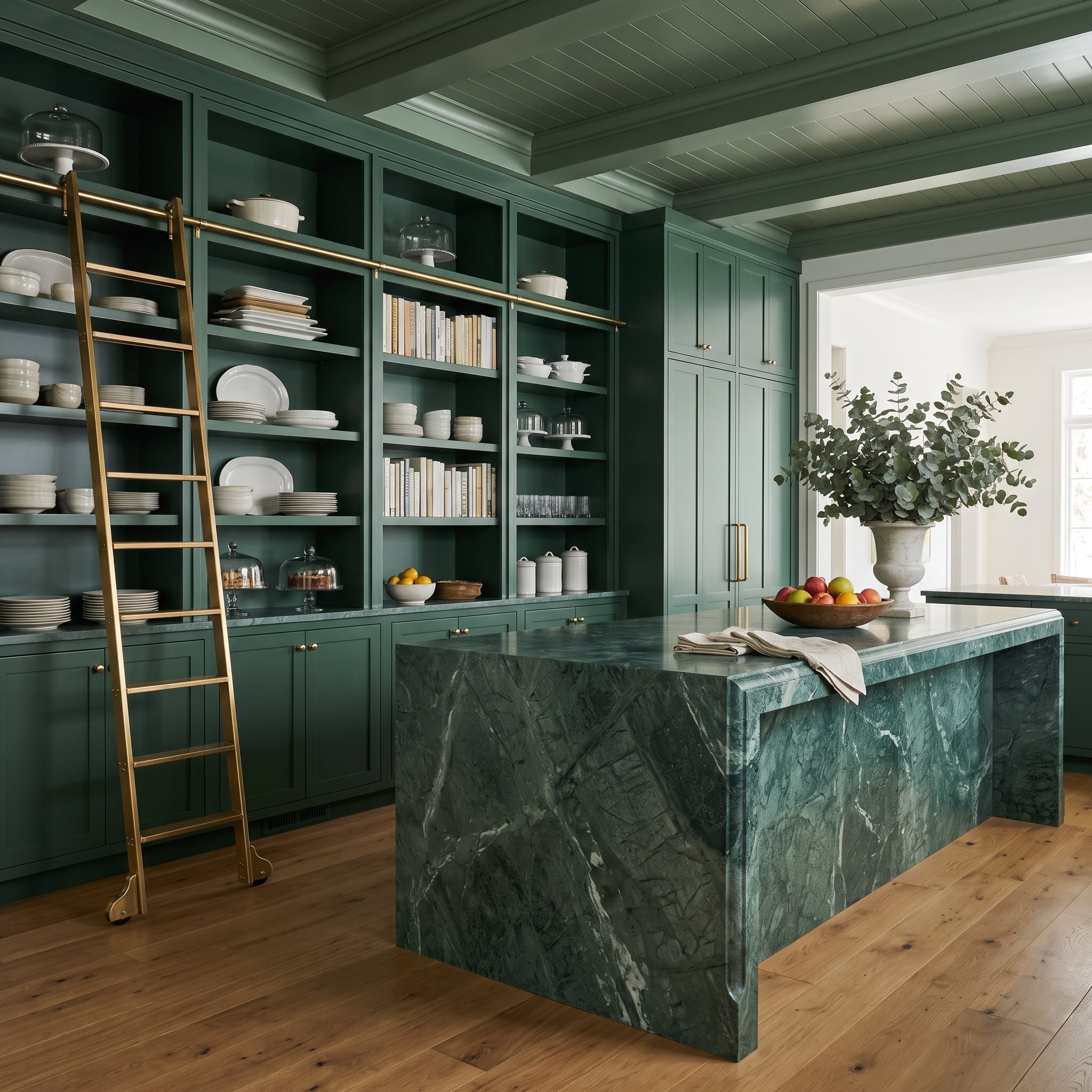 Deep forest-green kitchen with matching open shelving, brass rolling ladder, and dramatic green marble island