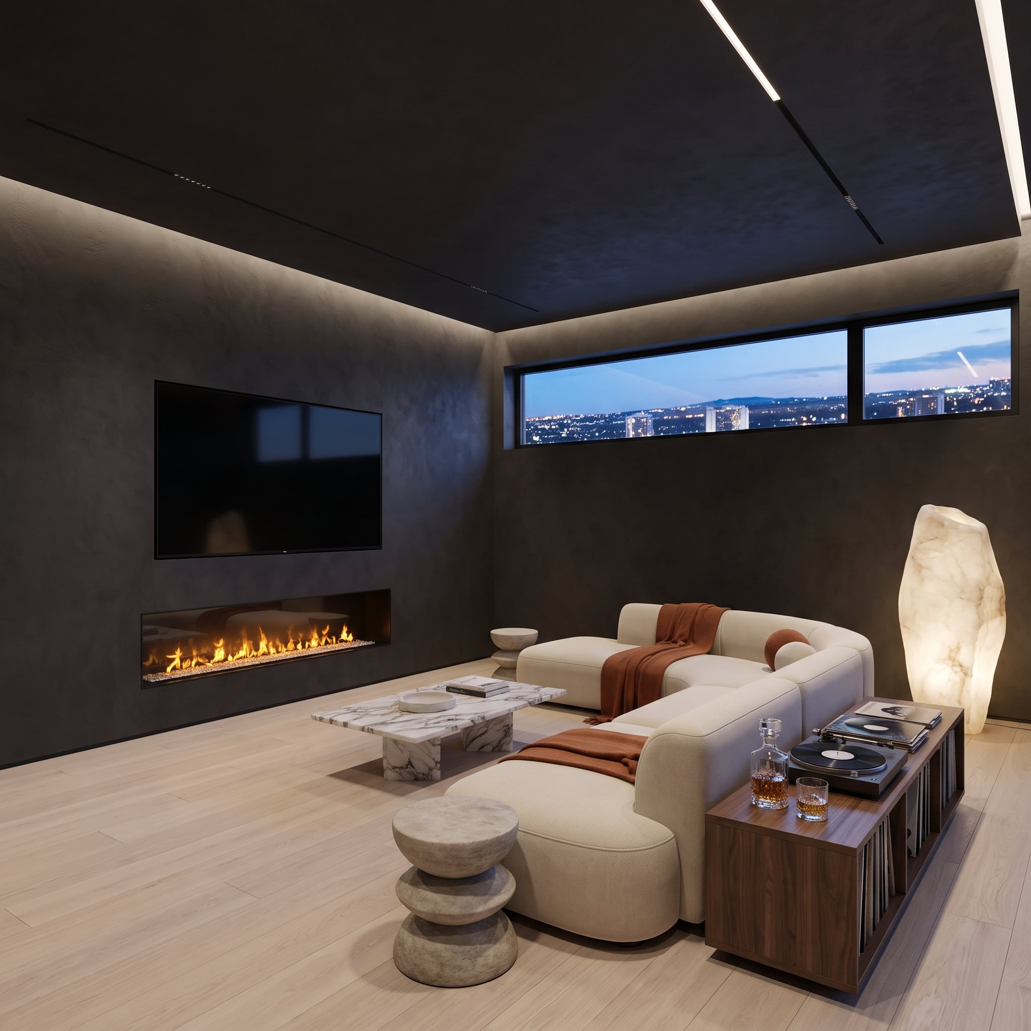 Dark microcement living room with recessed television above a linear fireplace, cream seating, alabaster lamp, and evening city views