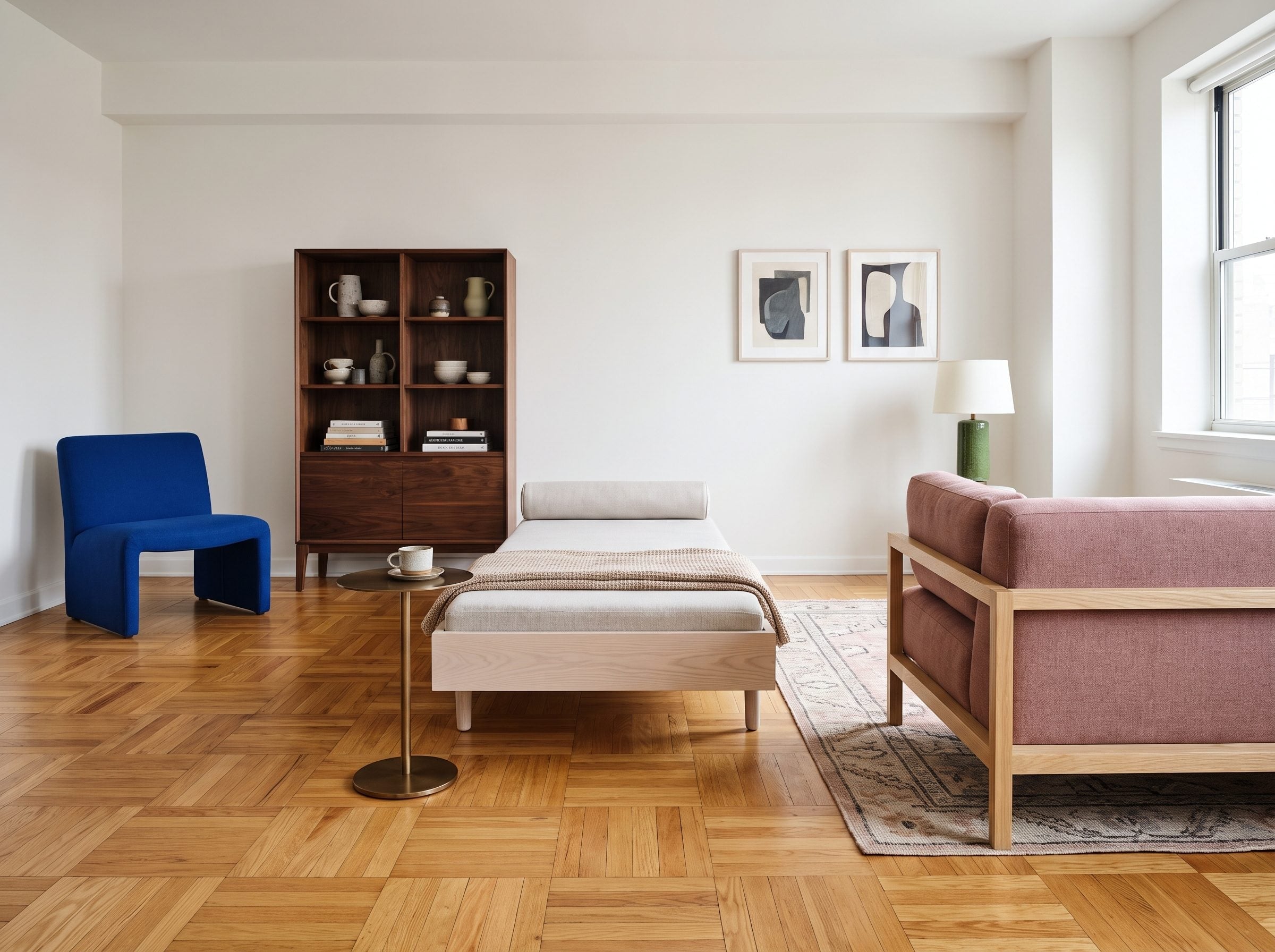 Room with geometric parquet flooring, dark walnut bookcase, pale ash daybed, and cobalt lounge chair