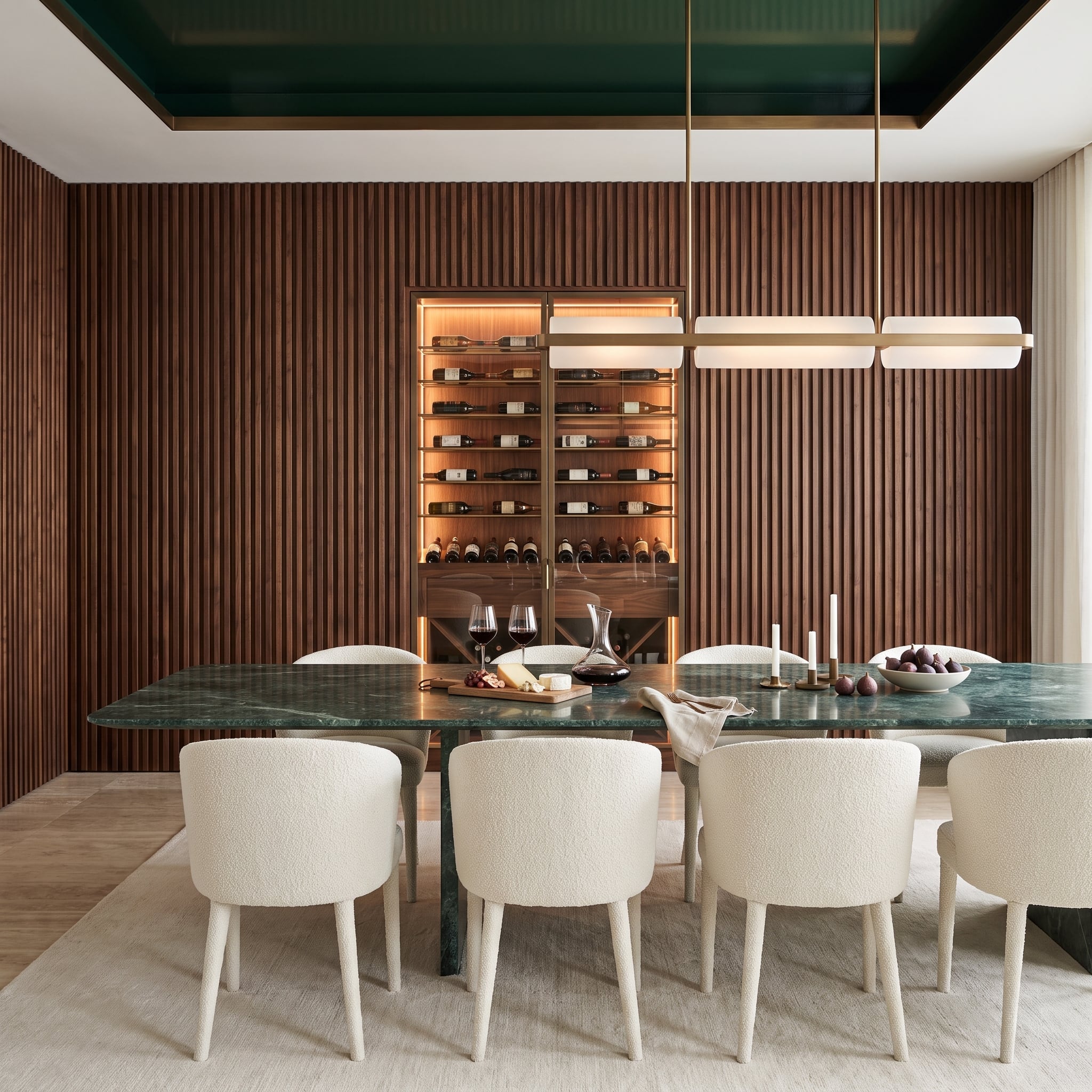 Dark walnut slat dining room wall with illuminated wine cabinet and green marble table